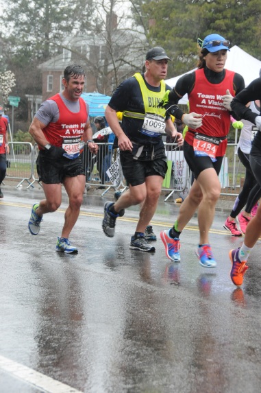 Vincent, Richard, and Dan running in the rain in the Boston Marathon