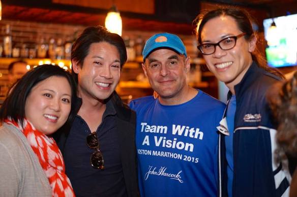 Vincent Hau and family meet NPR host and fellow sighted guide Peter Sagal at an event during Boston Marathon weekend